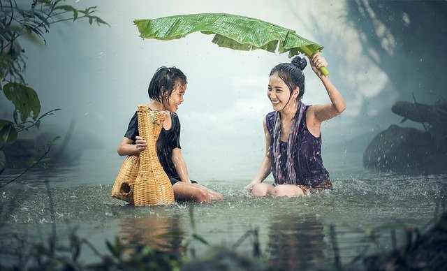Woman and child feeling good in the rain and with each other